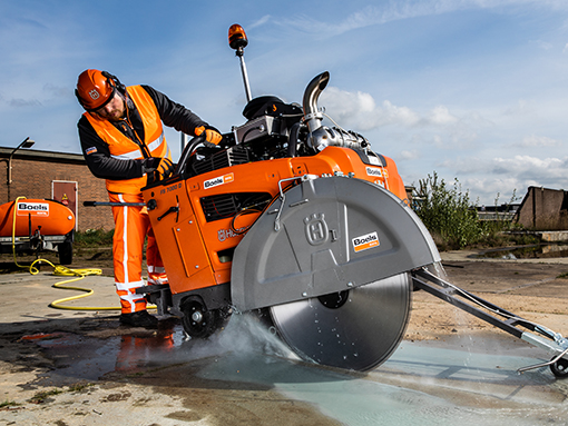 Man at work with an asphalt saw from Boels