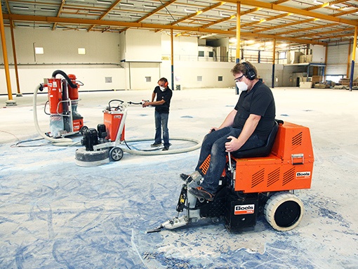 Man cuts asphalt with asphalt concrete saw